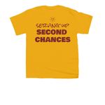 Serving up second chances, a Gold Youth Unisex Tee (back-view)