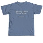Opening Doors Since 2006, a Blue Jean Comfort Colors Unisex Tee (back-view)